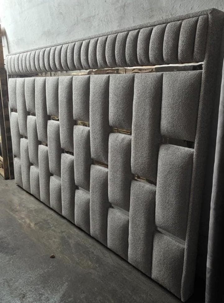 Woven basketweave upholstered headboard in taupe, with gold strips set between the panels.