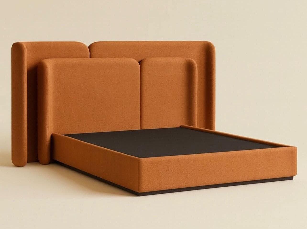 Rounded upholstered headboard in burnt orange with a matching bed base.